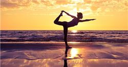 woman doing yoga on the beach